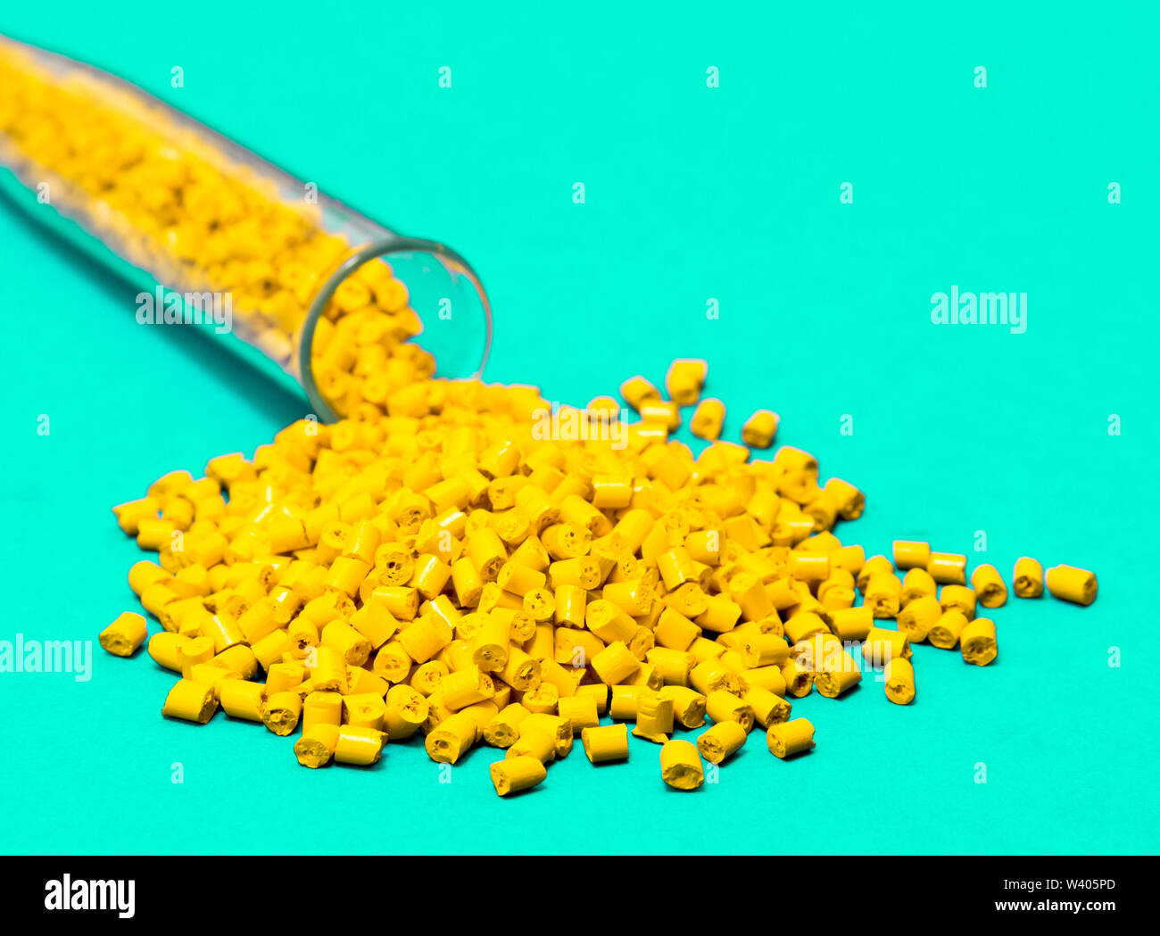 Plastic raw materials in granules for industry.Yellow Polymer on a blue background. Plastic