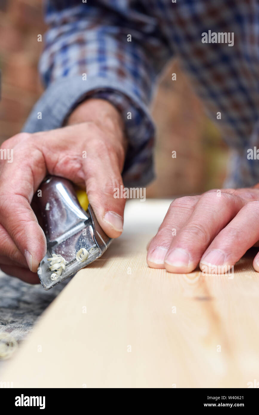 Close up of male hands doing woodwork using tools Stock Photo