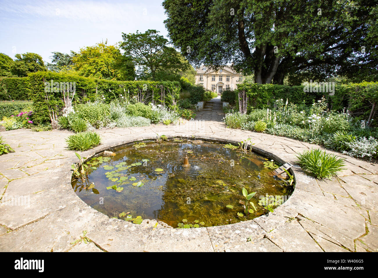 one of the Ponds in gardens of tiger lily in flower in Tintinhull