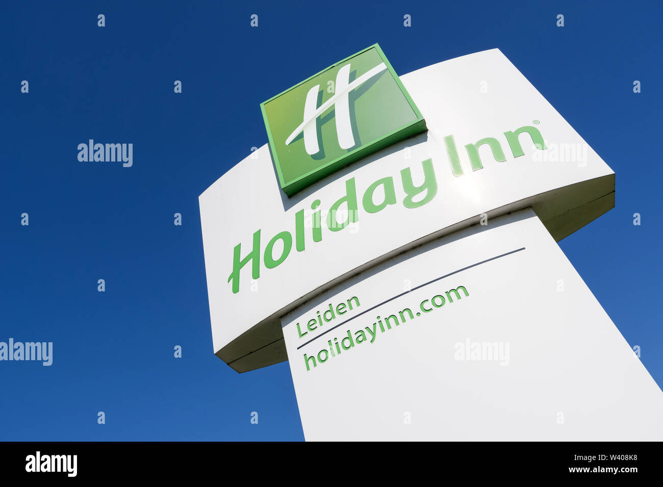 Holiday Inn Hotel sign against blue sky. Holiday Inn is a Britishowned