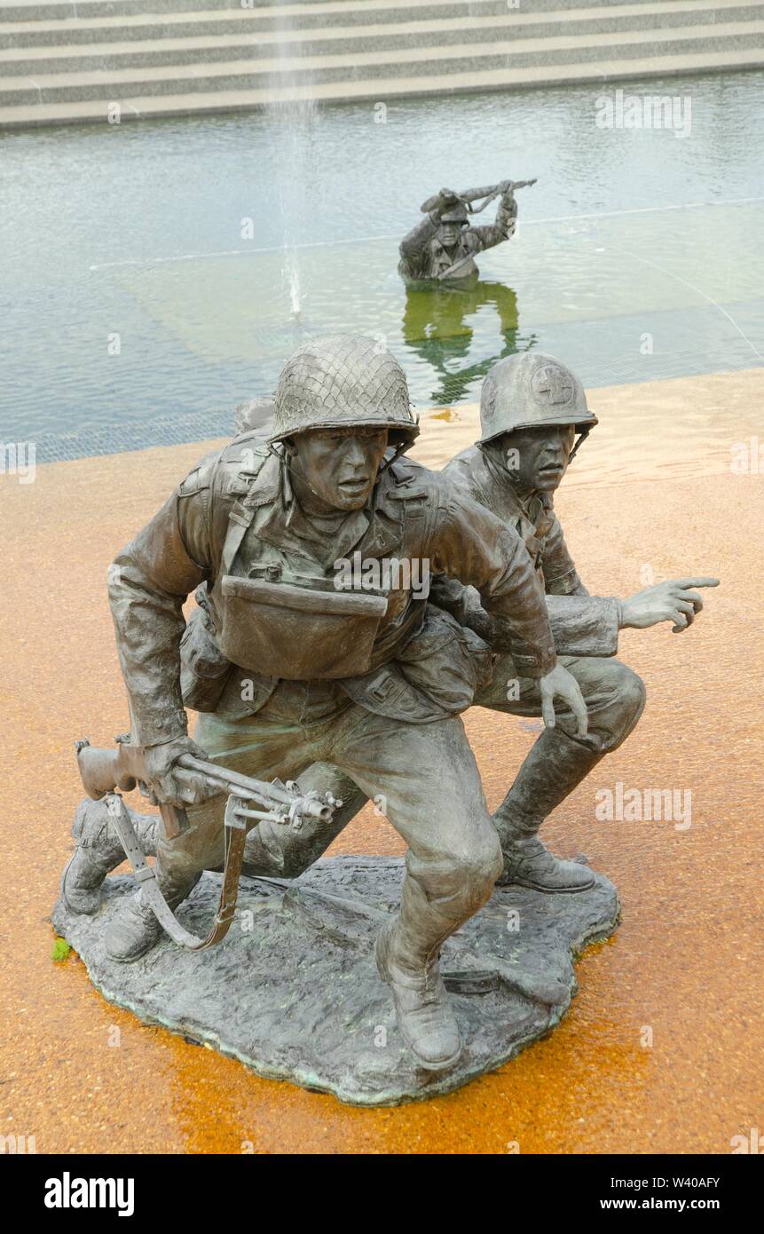 Statues of soldiers storming the beach at the National DDay Memorial