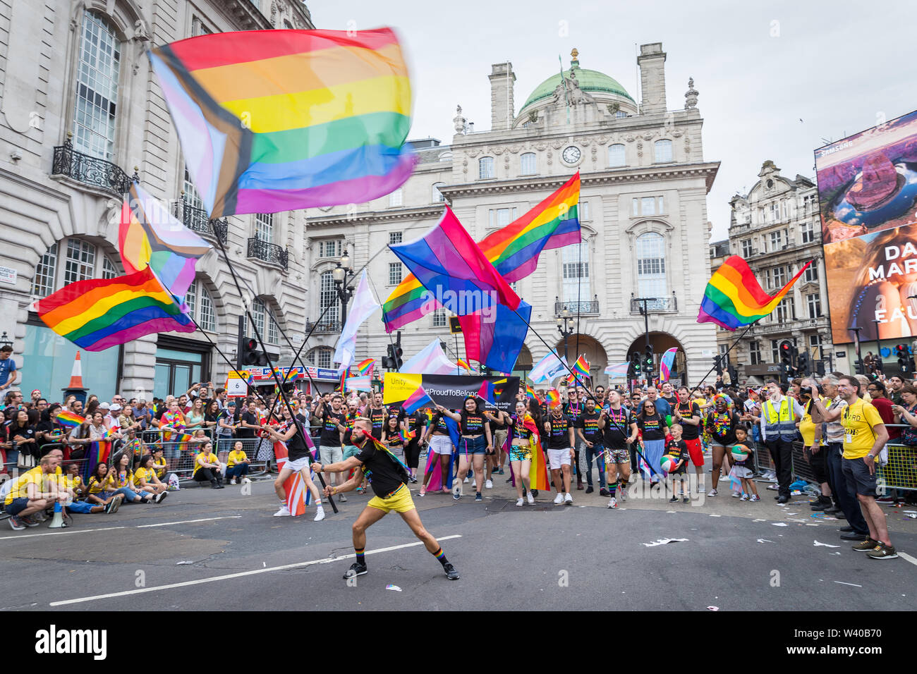 Revellers waving giant LGBT flags in Piccadilly Circus during the Pride par...