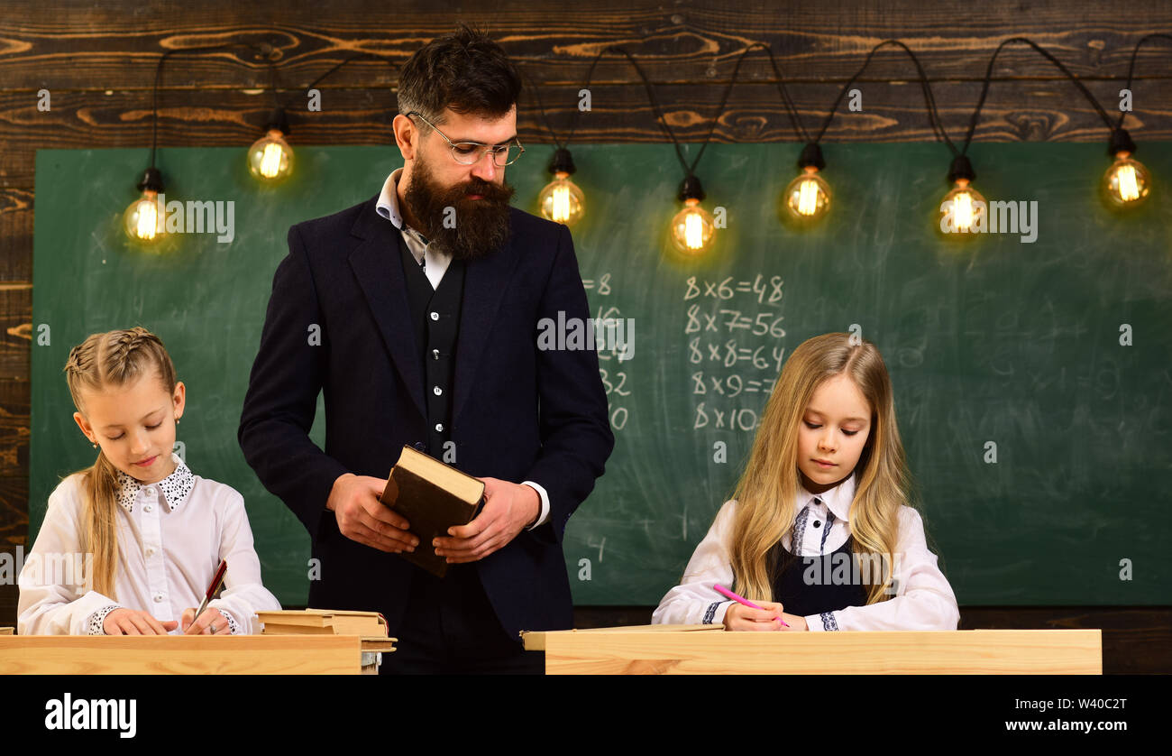 Child needs to stay focused to finish her work. Students build positive relationships with their teachers. Attentive schoolkid is doing his math homew Stock Photo