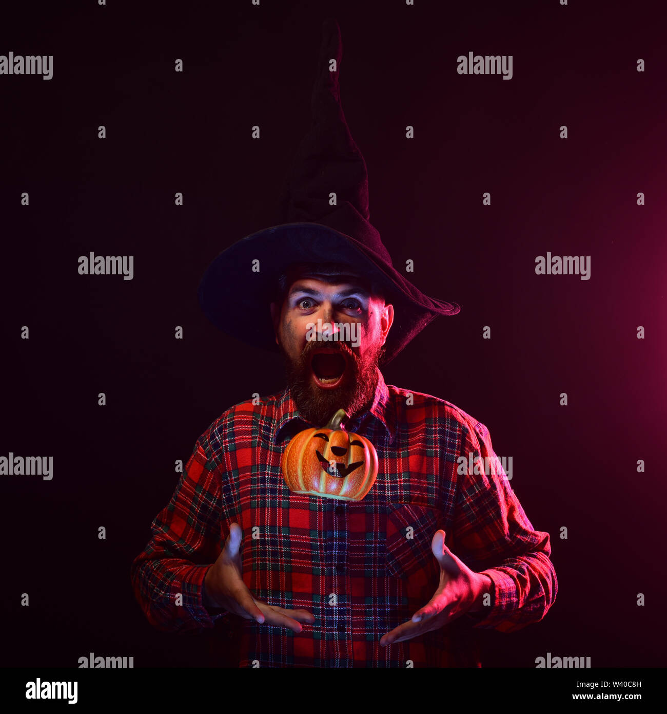 Halloween man with open mouth throwing pumpkin up Stock Photo Alamy