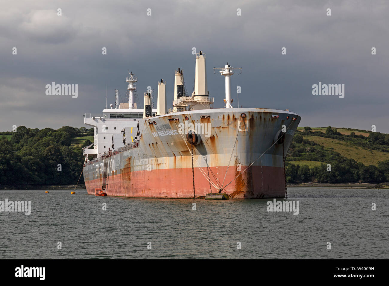 The SSI Reliance, a bulk cargo carrier registered in the Marshall Islands, anchored in the mouth of the Fall River in Cornwall, England. Stock Photo