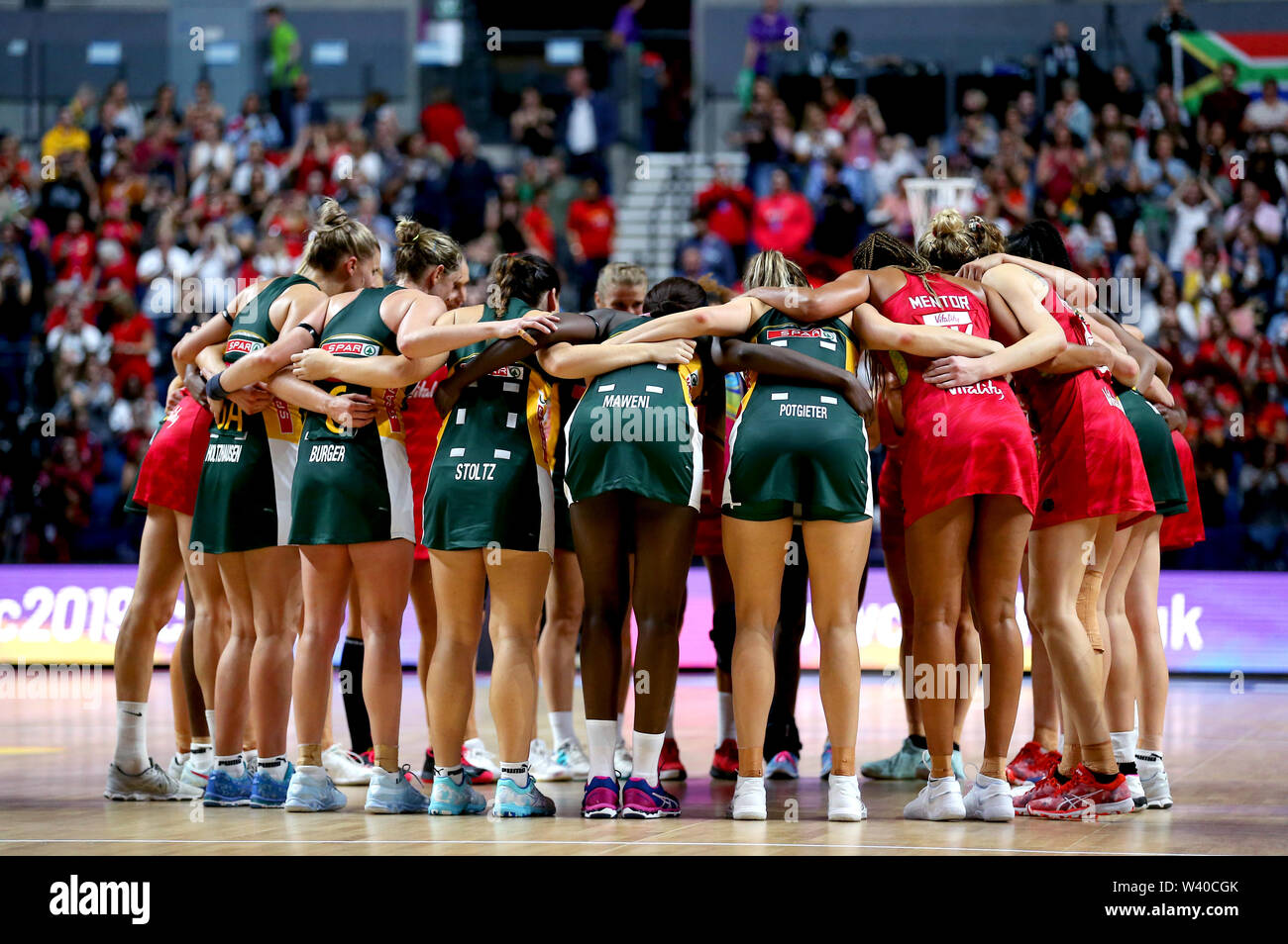 England players and South Africa players huddle together at the end of the Netball World Cup match at the MandS Bank Arena, Liverpool Stock Photo