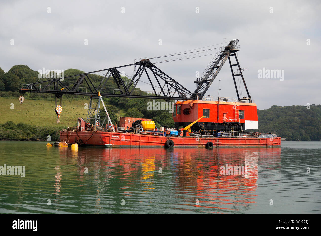 A Heavy Lift Crane Barge, number BD6072, owned by Keynvor Morlift, in the estuary of the Fal River in Cornwall, England. Stock Photo