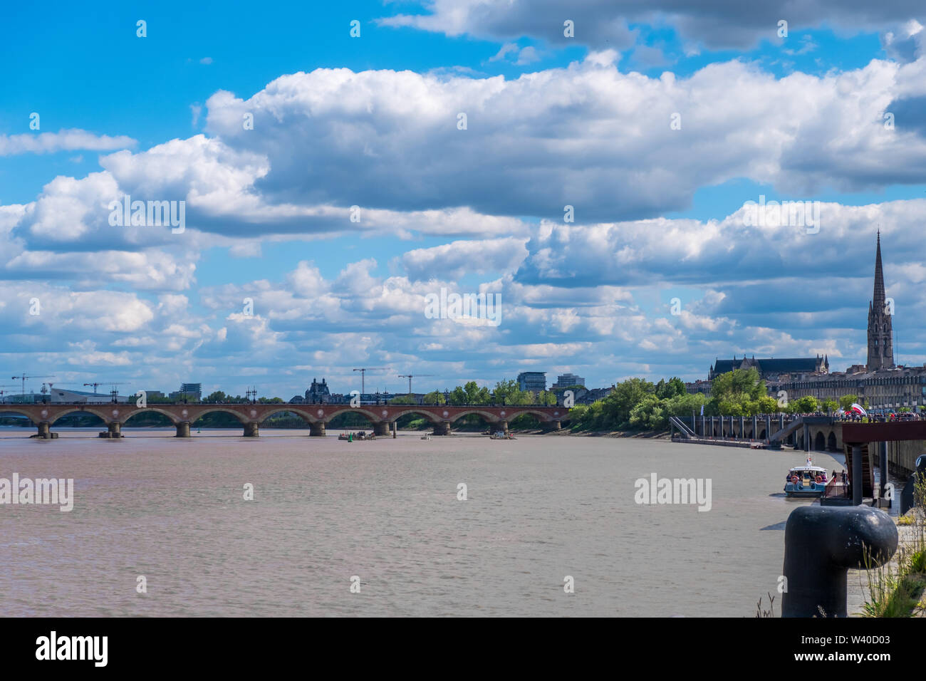 Bordeaux, France - May 5, 2019 : The Pont de Pierre Bridge. Passenger vessel moor at a pier on Garonne river in Bordeaux, Gironde, Aquitaine, France Stock Photo