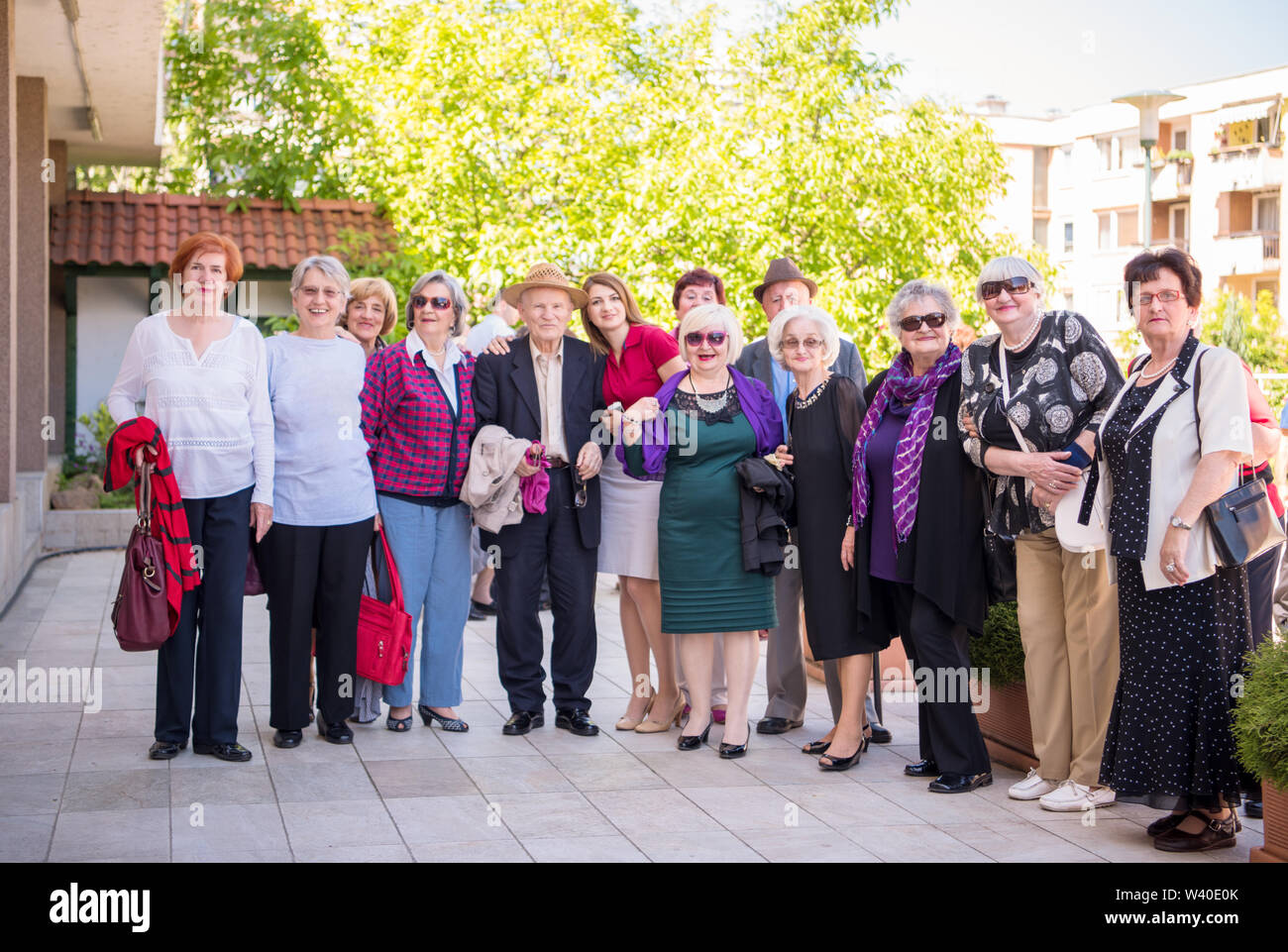 group portrait of senior people with geriatric nurse at park in front of a retirement home Stock Photo
