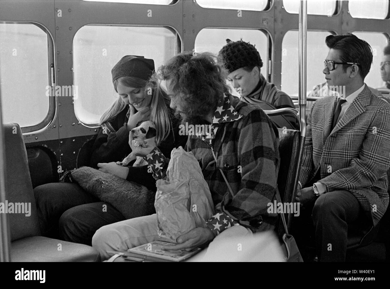 Hippy hippies American couple with pet puppy dog riding a bus in Haight-Ashbury San Francisco. 1969 USA 60s 1960s US HOMER SYKES Stock Photo