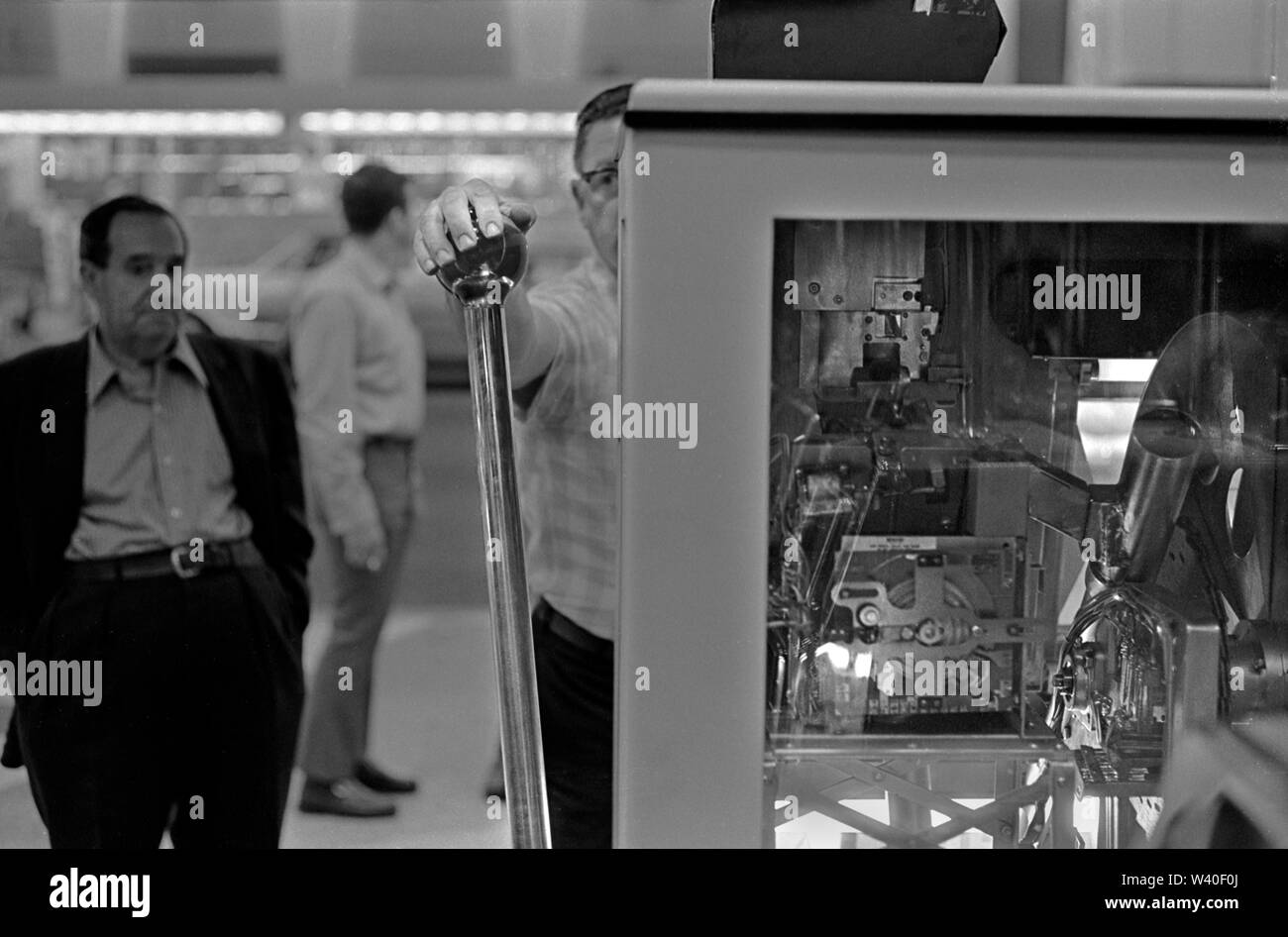 One armed bandits fruit machine, slot machines, man playing  gambling on Big Bertha a giant one arm bandit  1969, Reno Nevada Casino. USA 60s US HOMER SYKES Stock Photo