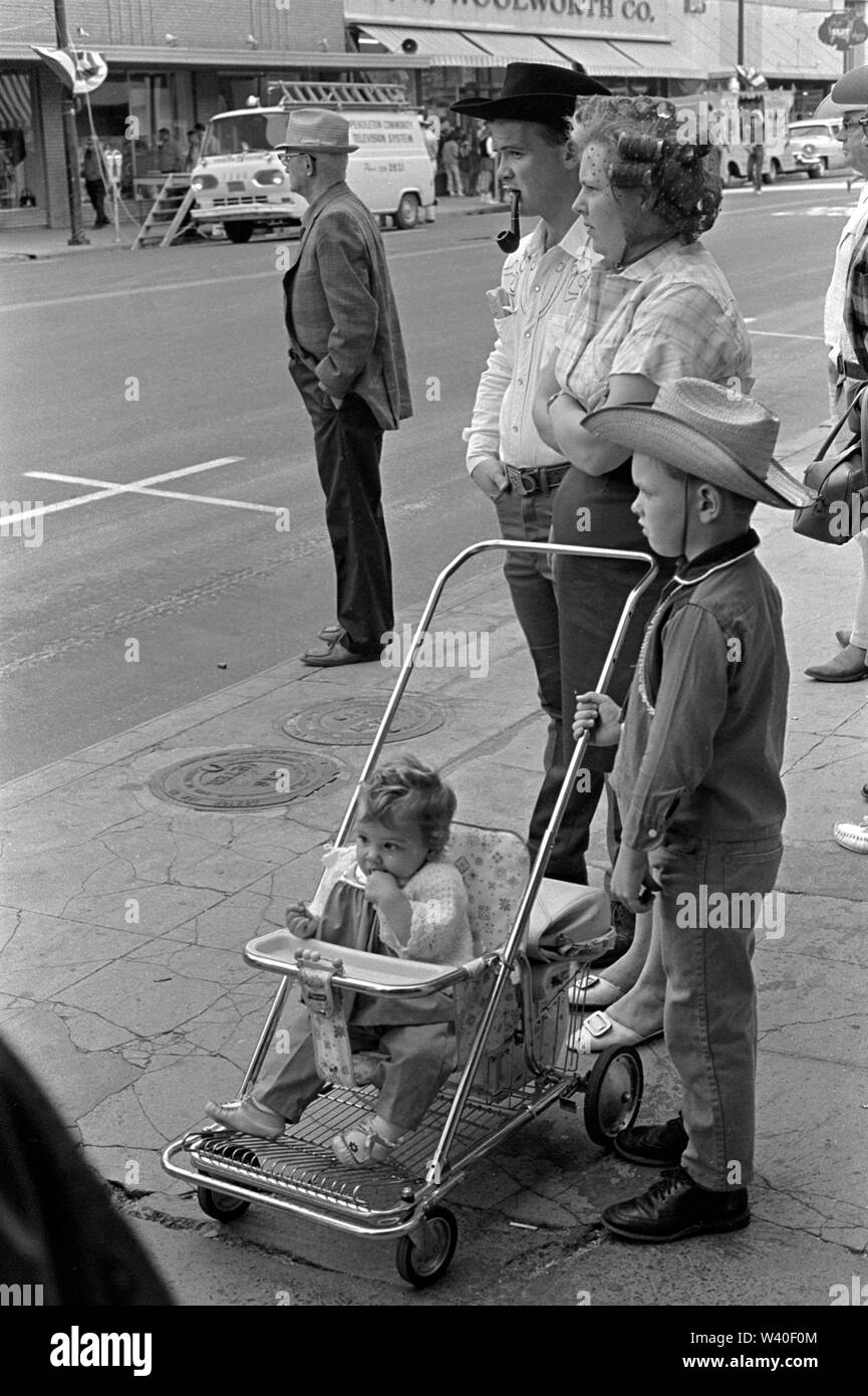 American caucasian family group together in street the man is smoking a pipe and wearing a cowboy hat and his wife is in her hair curlers also know as hair rollers. Pendleton, Oregon 1969, USA 60s US HOMER SYKES Stock Photo