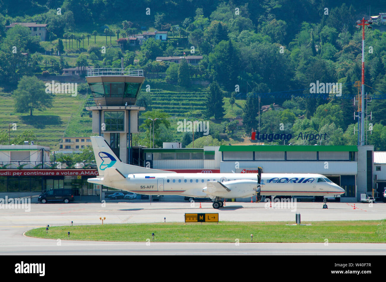 Agno, Ticino, Switzerland - 30th June 2019 : View on the Lugano-Agno airport with a parked air Adria Airplane located in the Canton of Ticino, Switzer Stock Photo