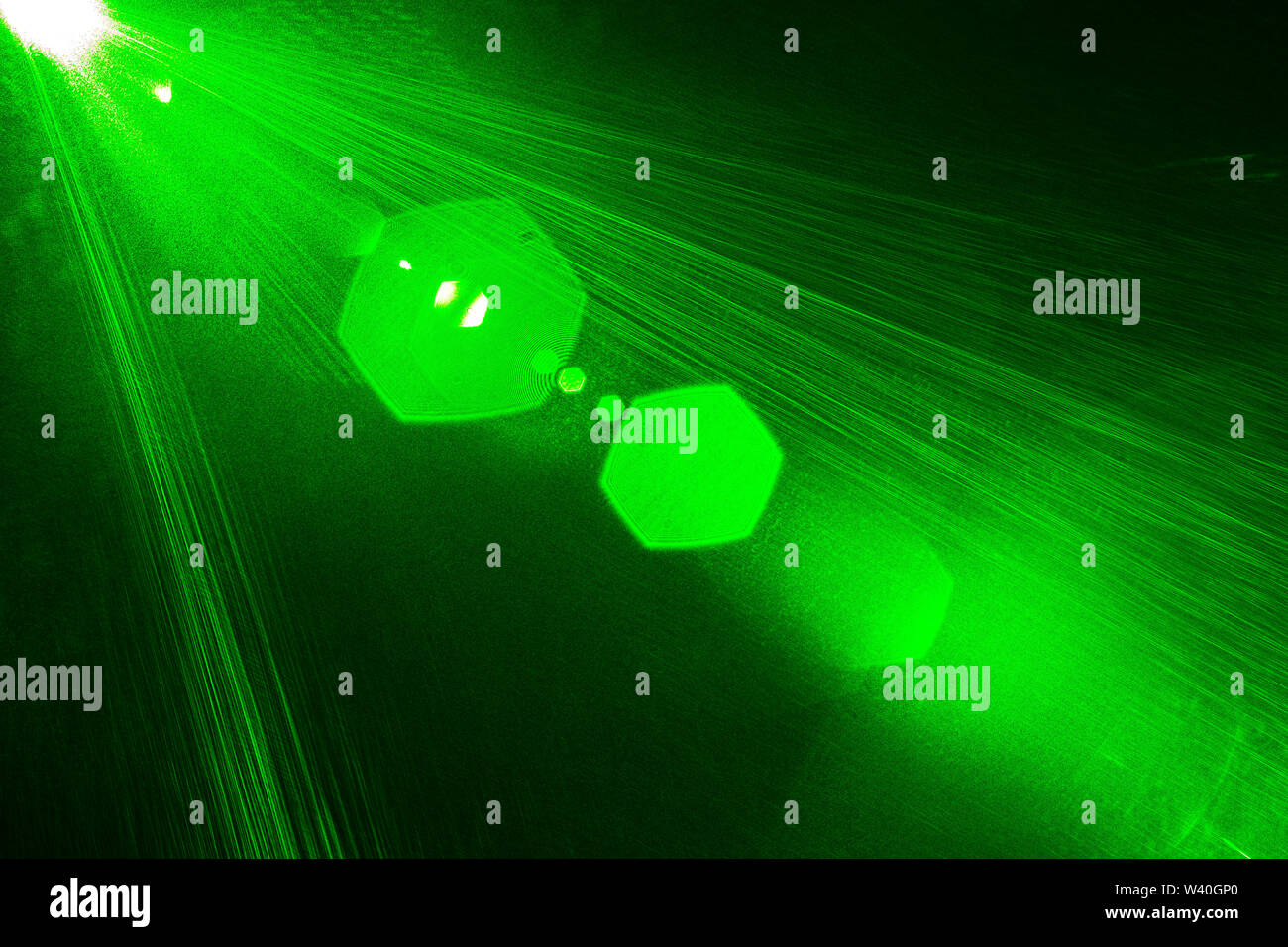 Camera lens flare by laser light create hexagons of objective iris