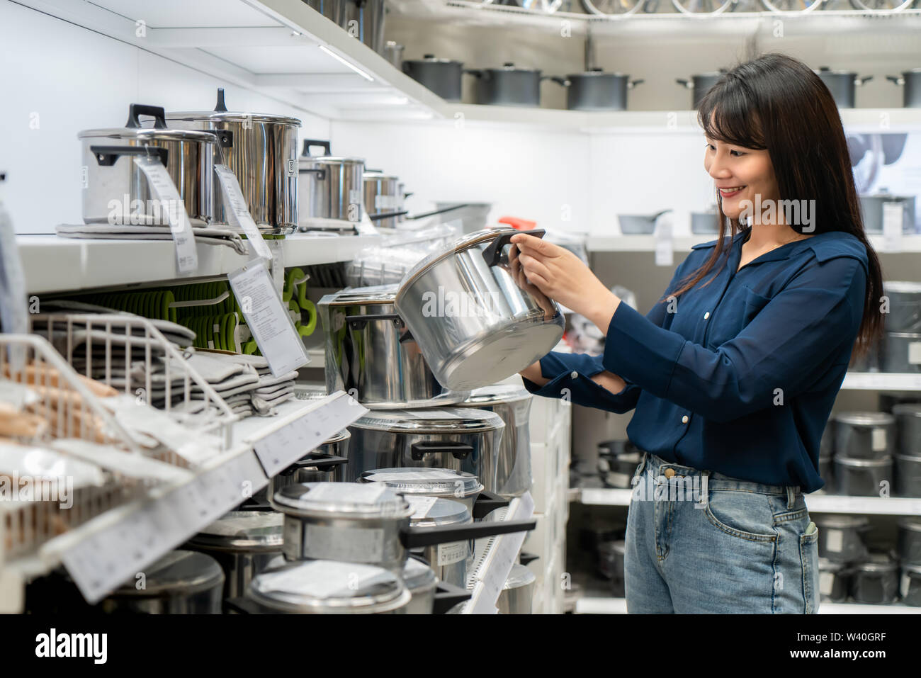 Asian women are choosing to buy new kitchenware in the mall. Shopping for groceries and housewares are needed in markets, supermarkets or big shopping Stock Photo