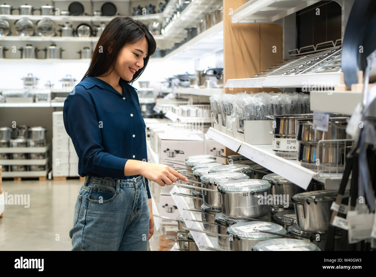 Asian women are choosing to buy new kitchenware in the mall. Shopping for groceries and housewares are needed in markets, supermarkets or big shopping Stock Photo