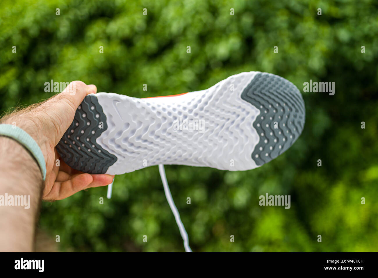 Paris, France - Jul 8, 2019: Athlete man hand holding presenting new  running shoes Nike Epic React Flyknit 2 special sole with carbon insert  Stock Photo - Alamy