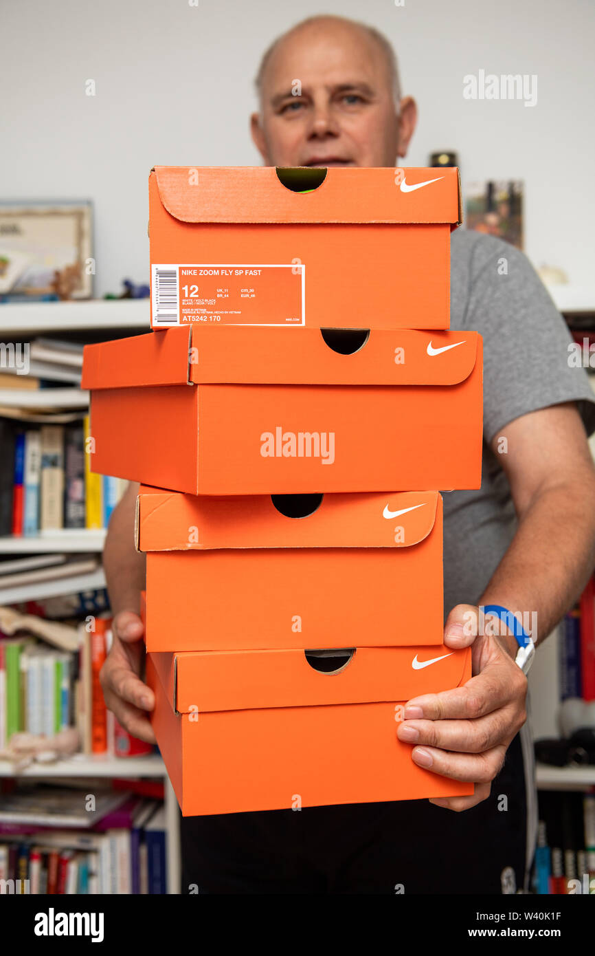 Paris, France - Jul 10, 2019: Athlete senior man holding in hands multiple  red cardboards with Nike Running shoes in living room after online  e-commerce order Stock Photo - Alamy