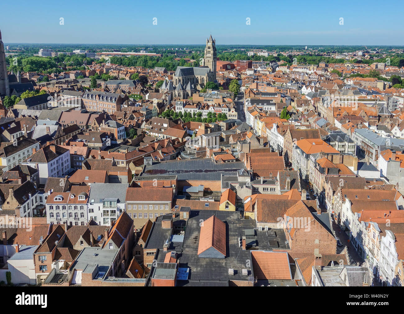 Bruges, Flanders, Belgium -  June 17, 2019: View from top of Belfry tower, Halletoren, along Steenstraat Southwest. Red roofs Cathedral tower, flat co Stock Photo