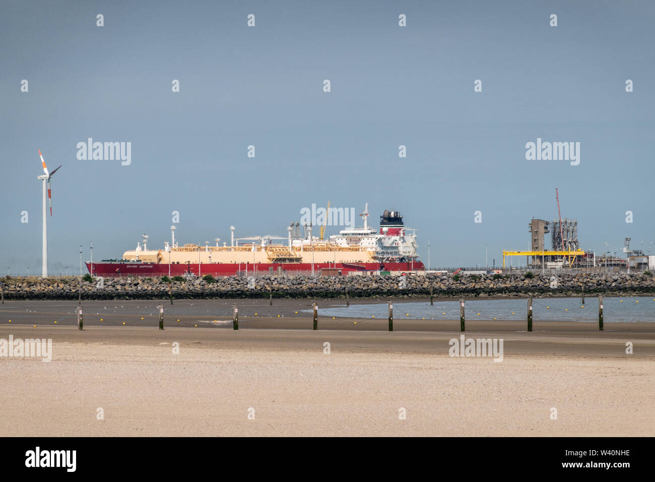 Zeebrugge, Flanders, Belgium -  June 18, 2019: British Saphire LNG tanker docked at LNG terminal in port of Zeebrugge under blue sky as seen from beac Stock Photo