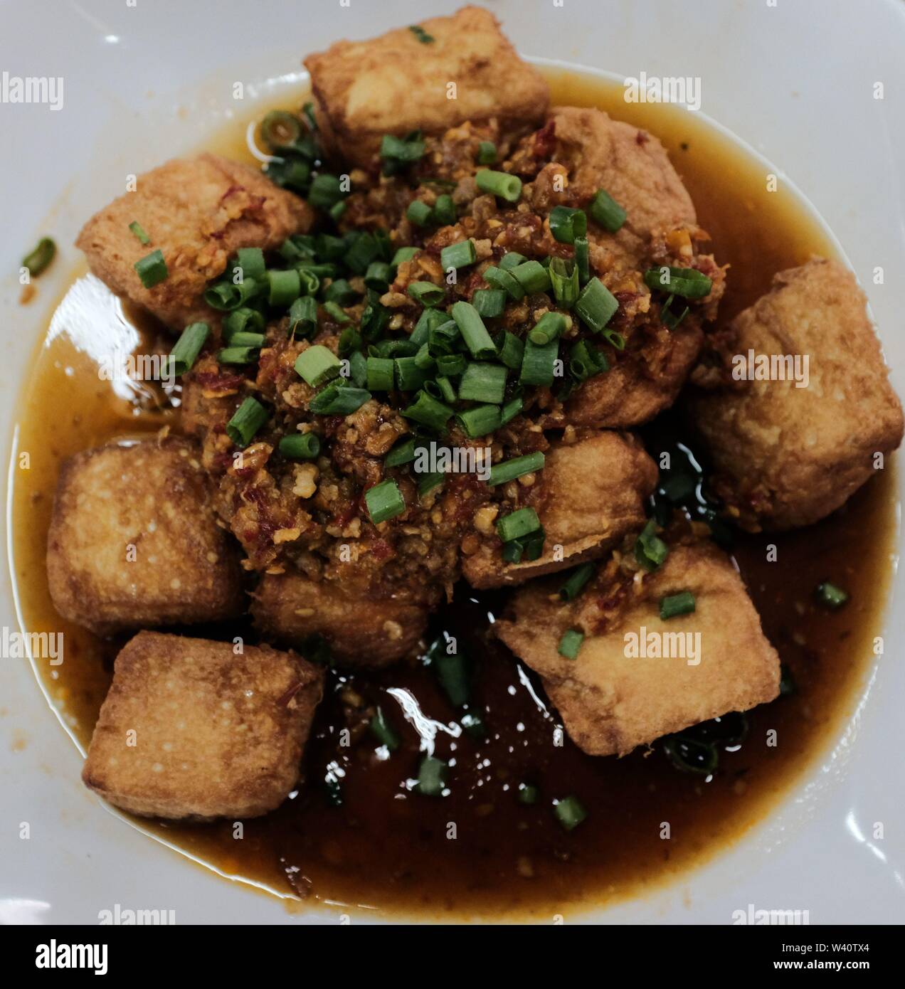 Fried tofu in sauce Stock Photo - Alamy