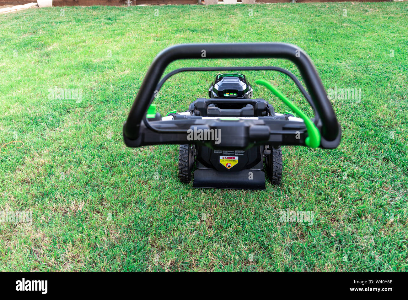 Battery powered 56 volt electric lawnmower for eco lawn care Stock Photo