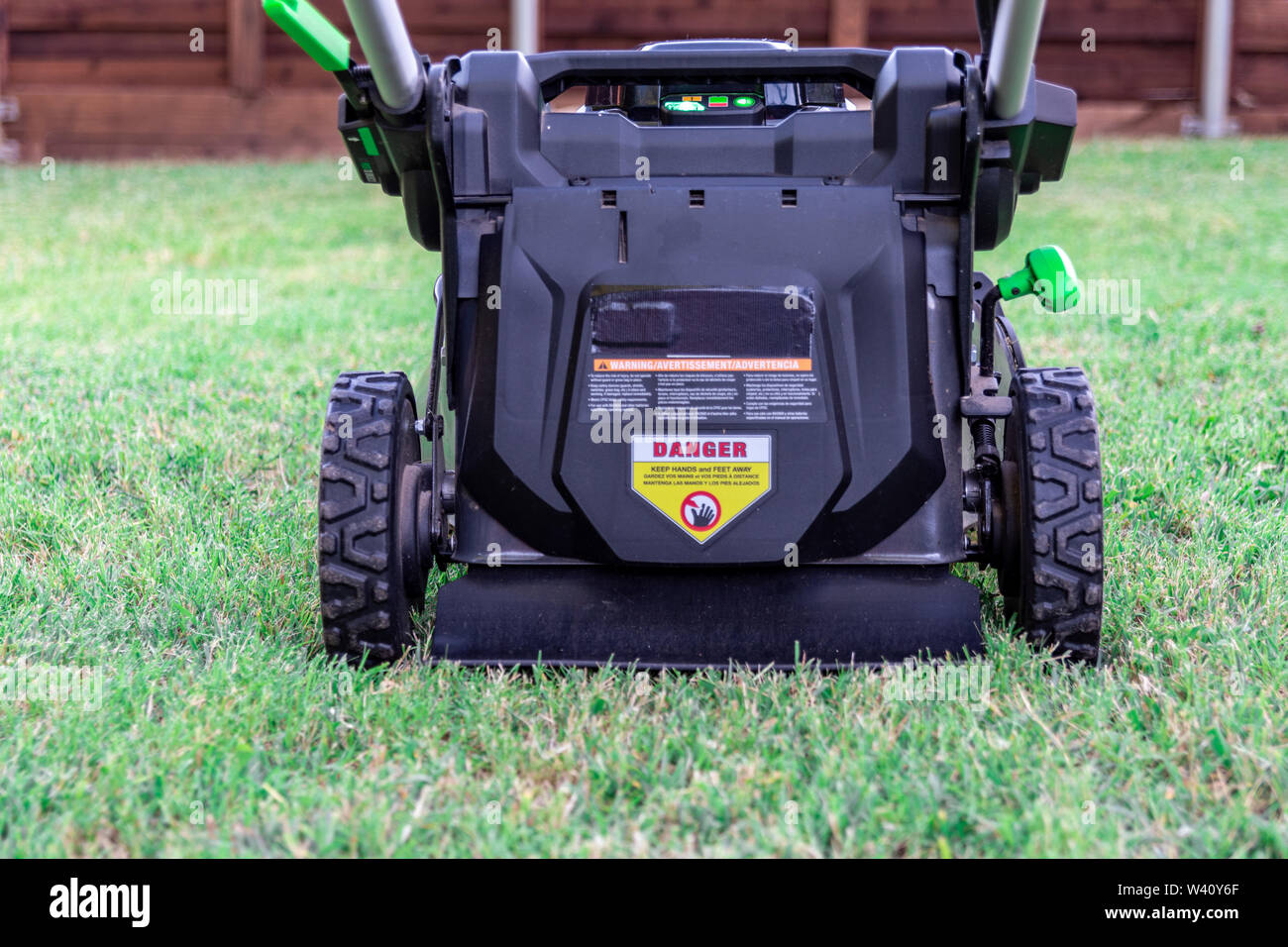 Battery powered 56 volt electric lawnmower for eco lawn care Stock Photo