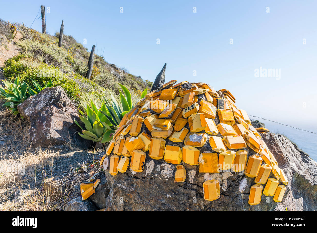 A creative sculpture made up of orange and yellow reflective highway markers located on the side of highway 1 in California's Central Coast near Big S Stock Photo