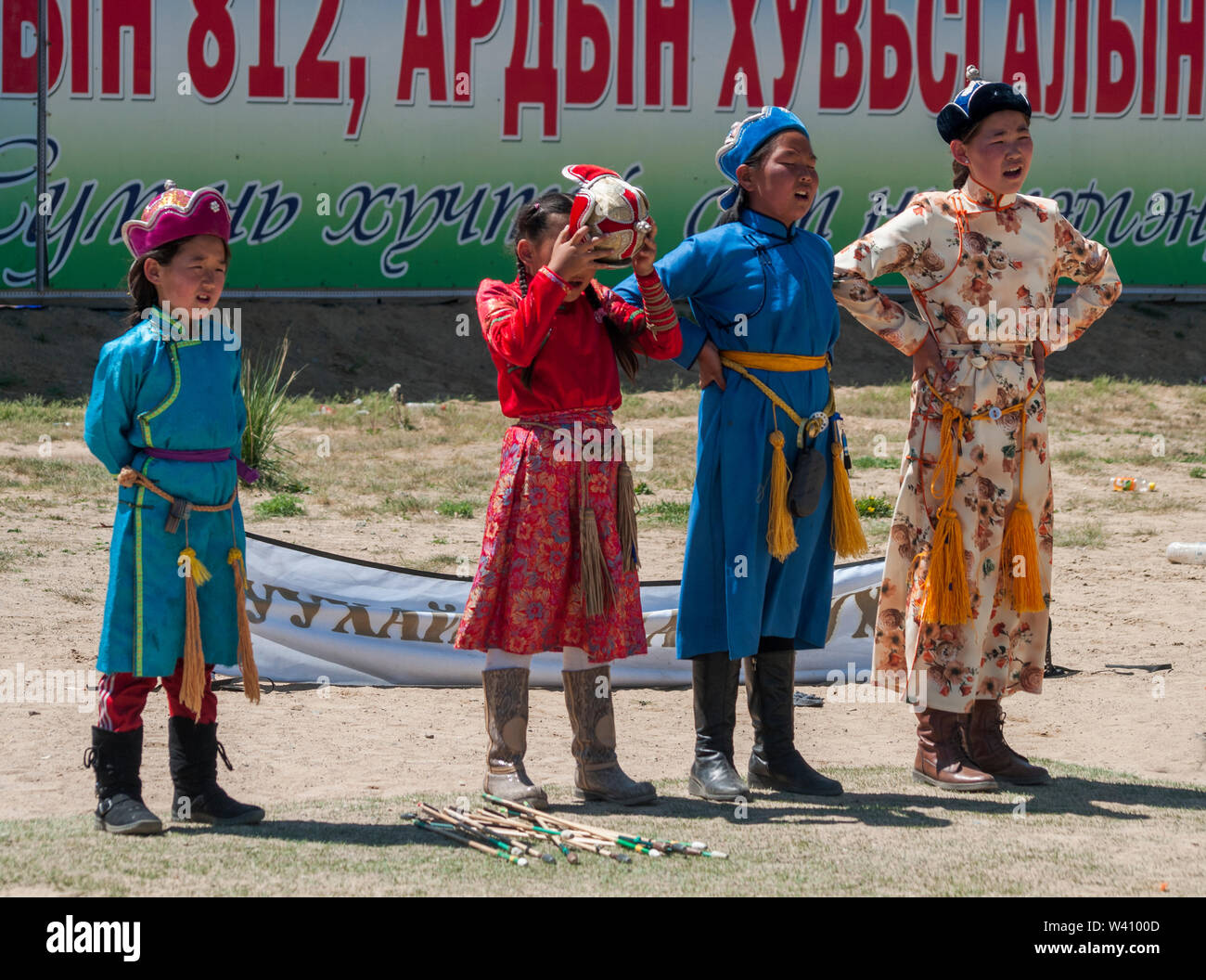 Girls in costume observe the traditional archery practice at the National Stadium, Ulaanbaatar, Mongolia Stock Photo