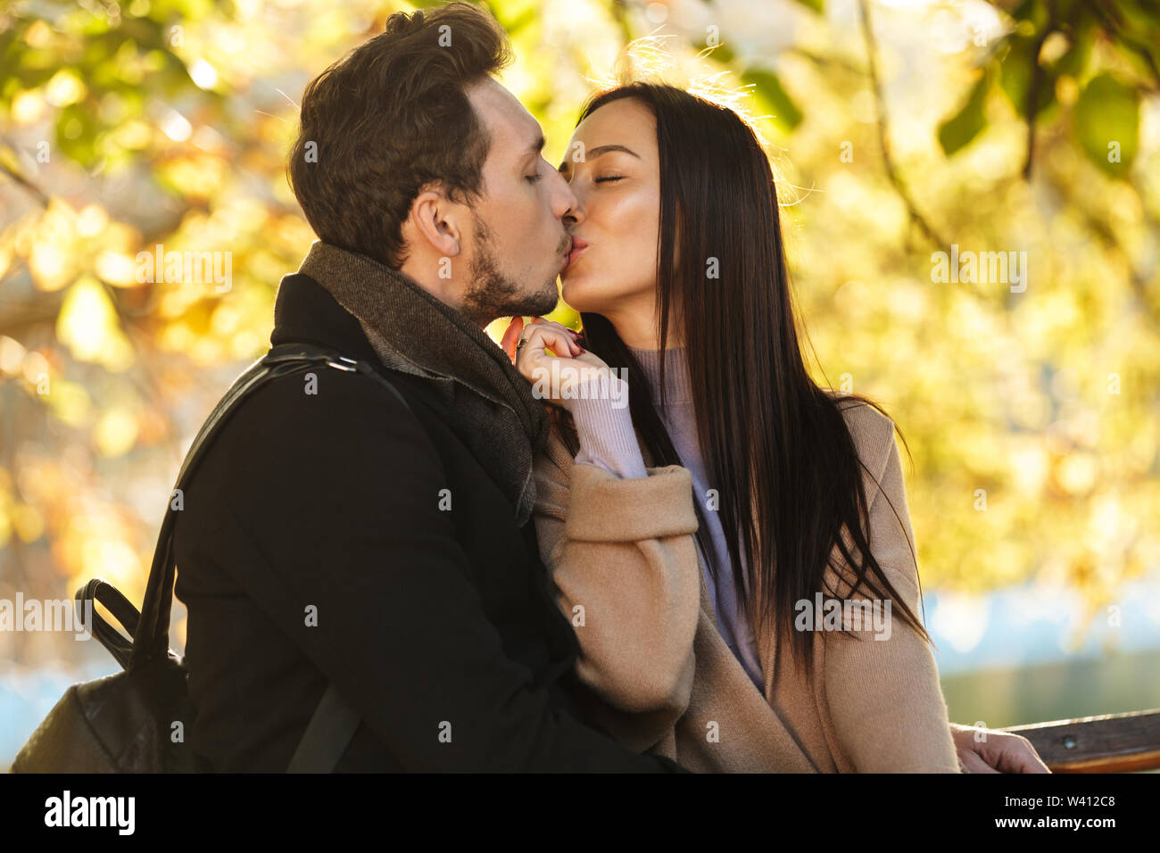 Image of a happy young beautiful loving couple posing walking outdoors ...