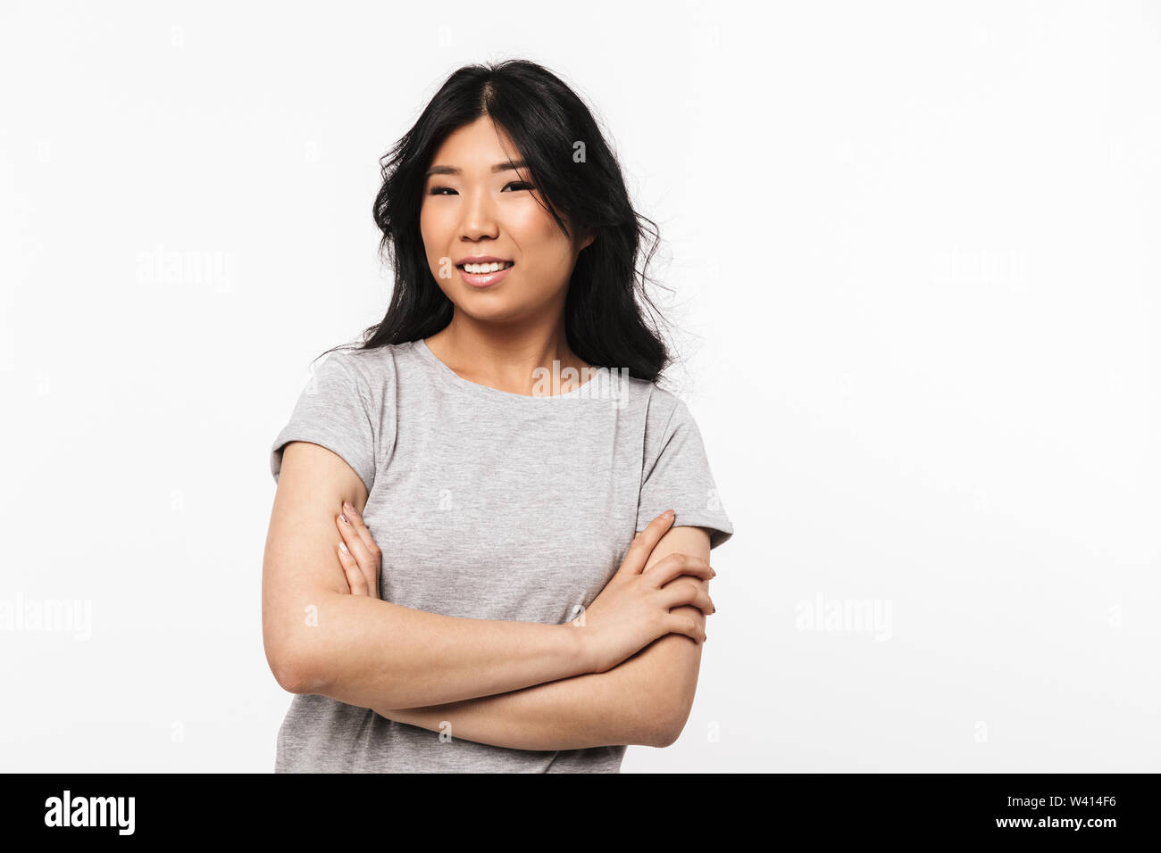 Image of asian beautiful young woman posing isolated over white wall ...