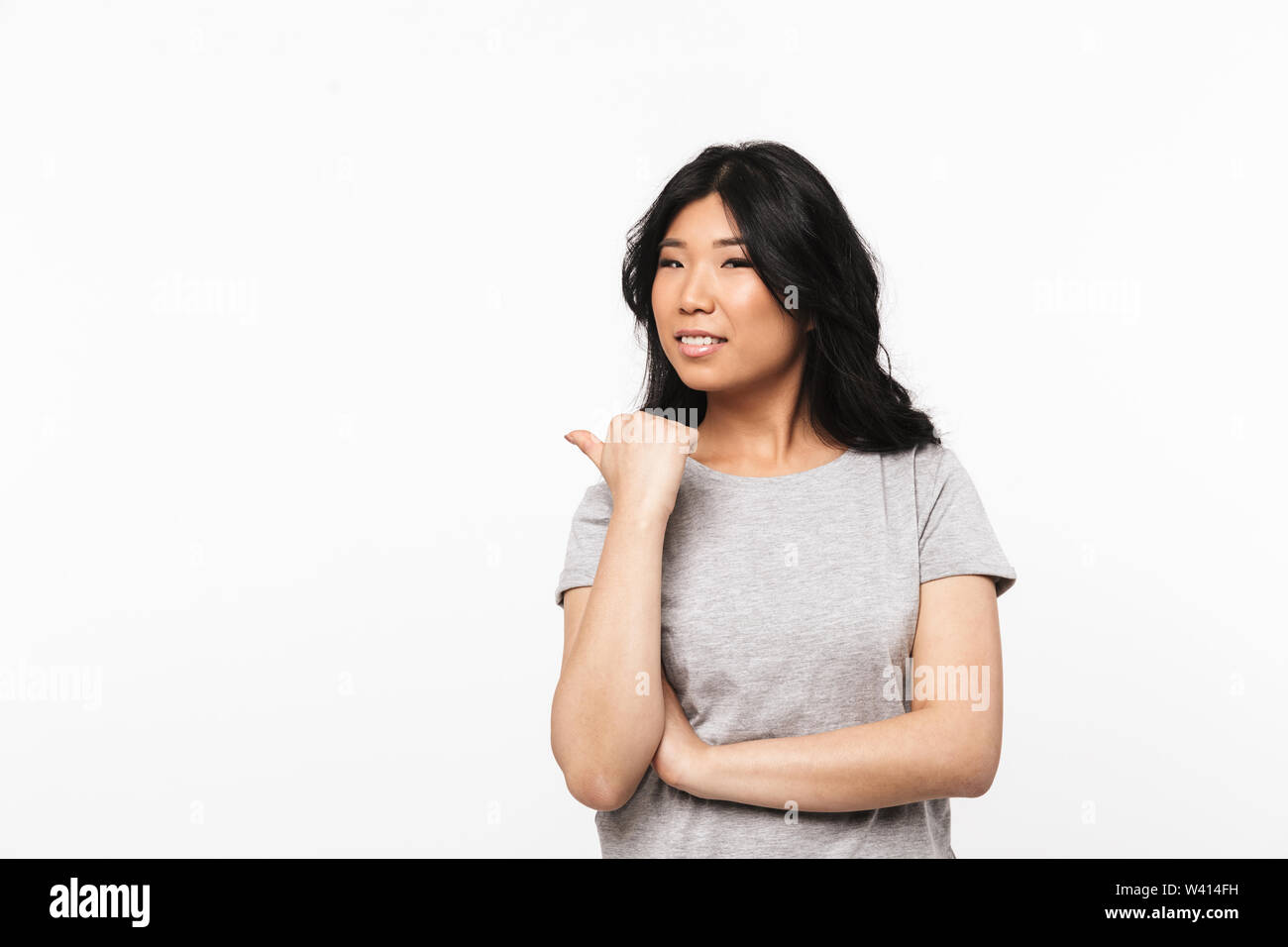 Image of asian beautiful young woman posing isolated over white wall ...