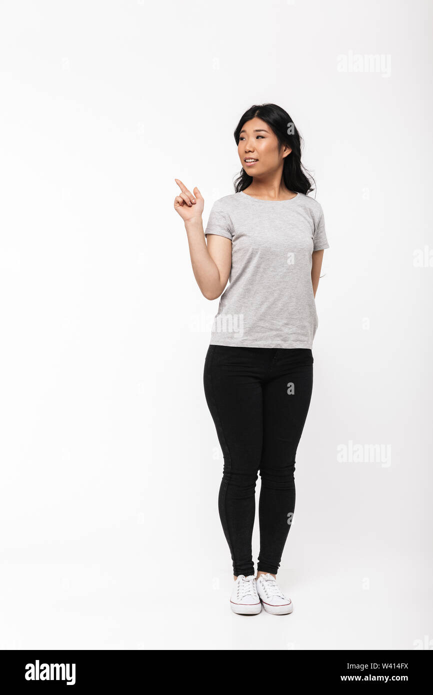 Image of asian beautiful young woman posing isolated over white wall ...