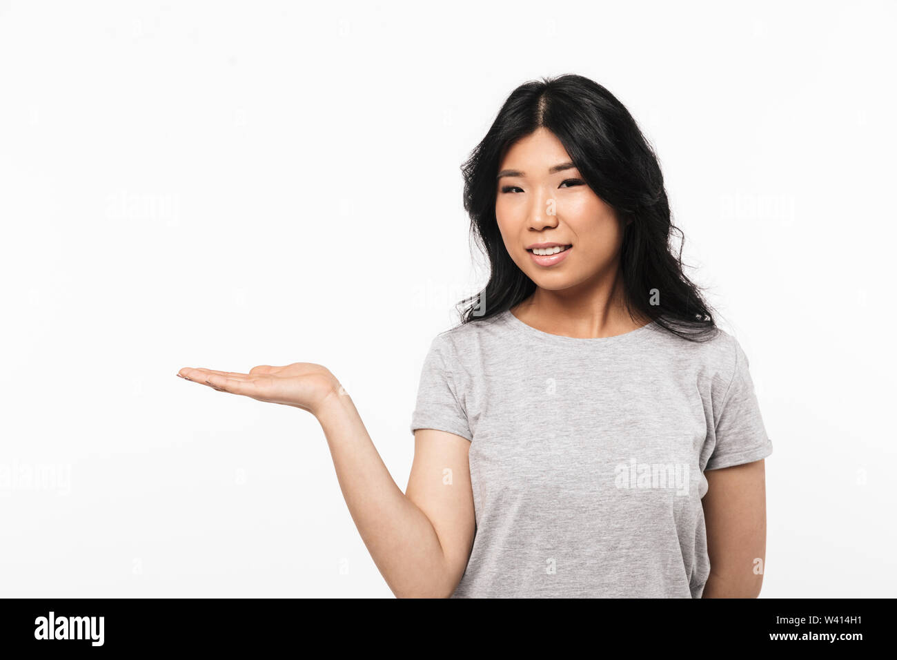 Image of asian happy beautiful young woman posing isolated over white ...