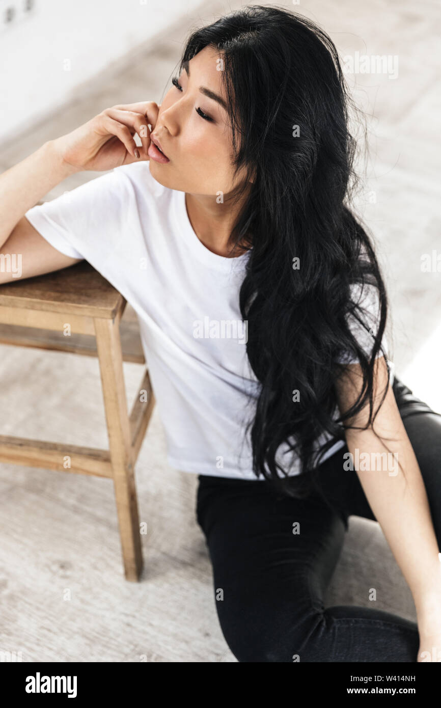 Image of asian beautiful young woman posing isolated over white wall ...