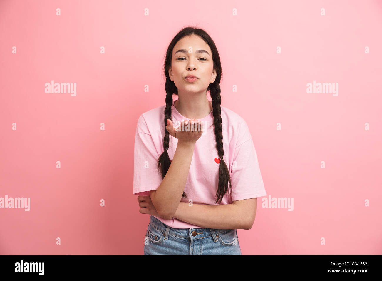 Image of caucasian attractive girl with two braids smiling and looking ...