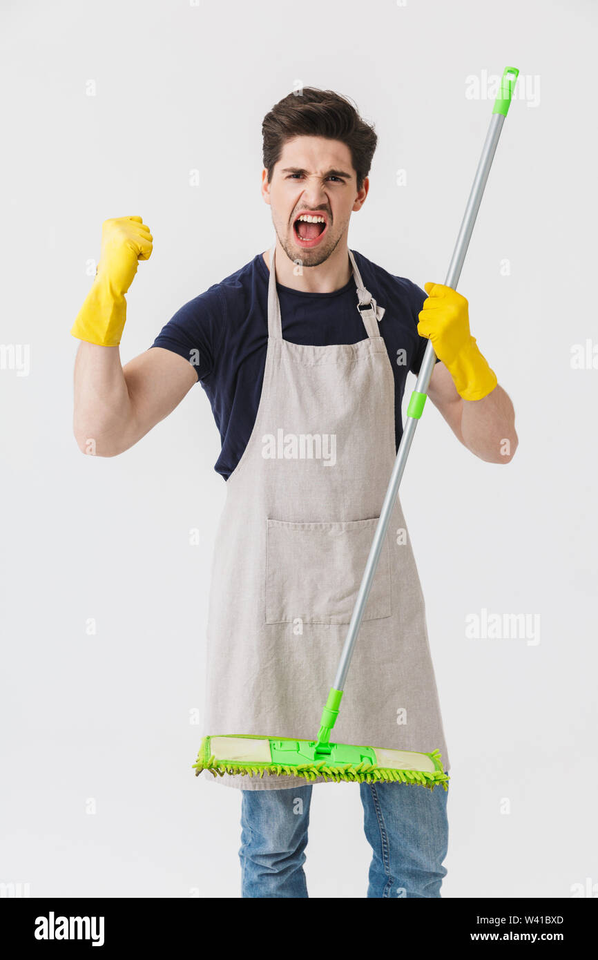 Photo of handsome young man wearing yellow rubber gloves for hands ...