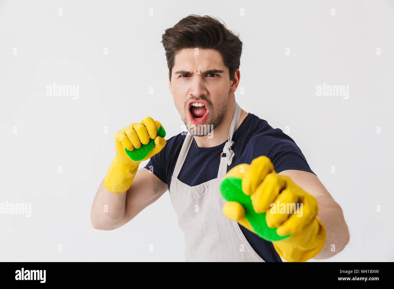 Photo of caucasian young man wearing yellow rubber gloves for hands ...