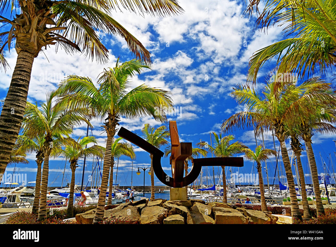Lanzarote Puerto Calero harbour and marina against blue sky white cloud