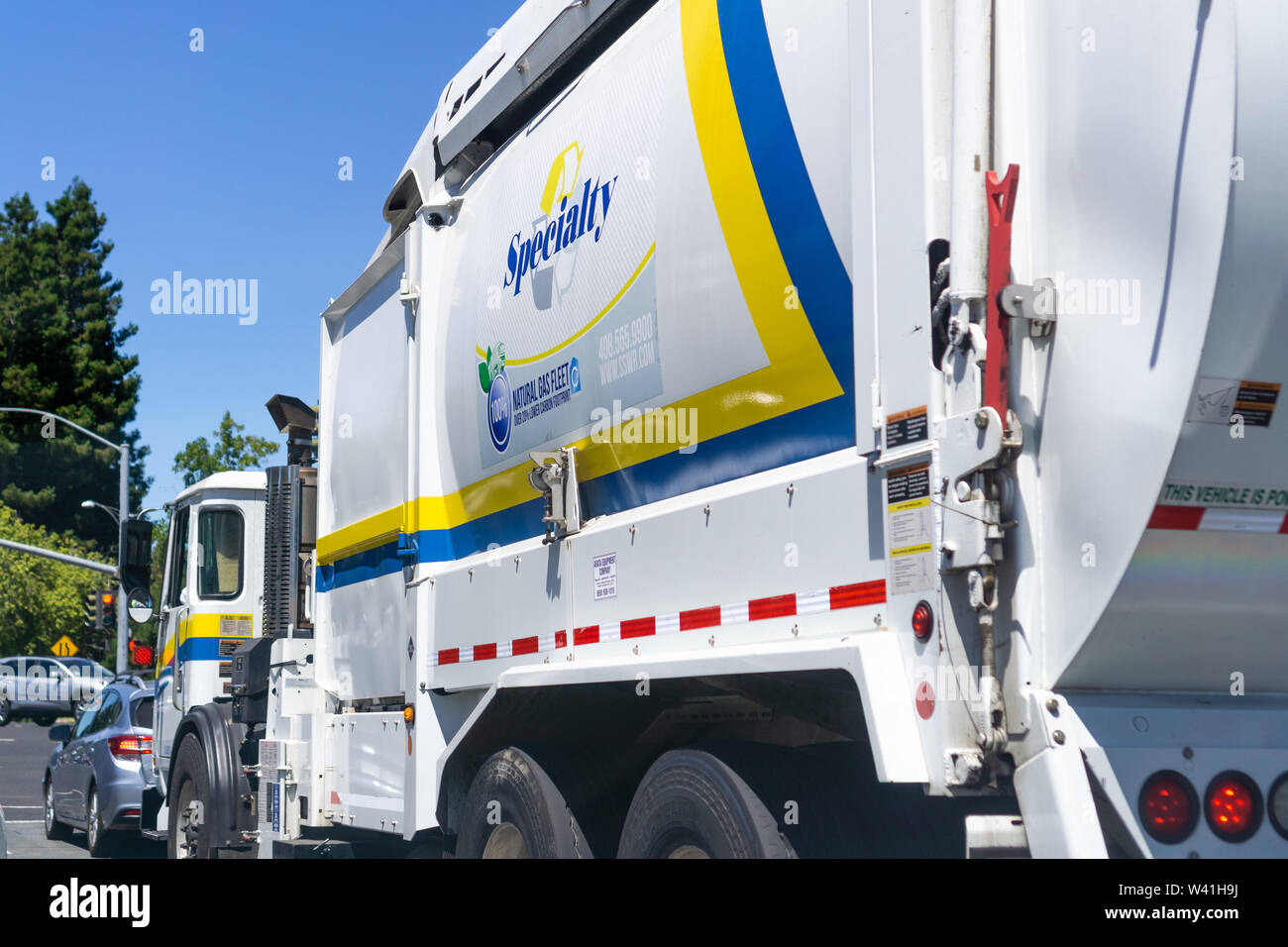 July 11, 2019 Sunnyvale / CA / USA - Specialty Solid Waste & Recycling (SSWR) vehicle driving on a street; Specialty is providing garbage hauling and Stock Photo