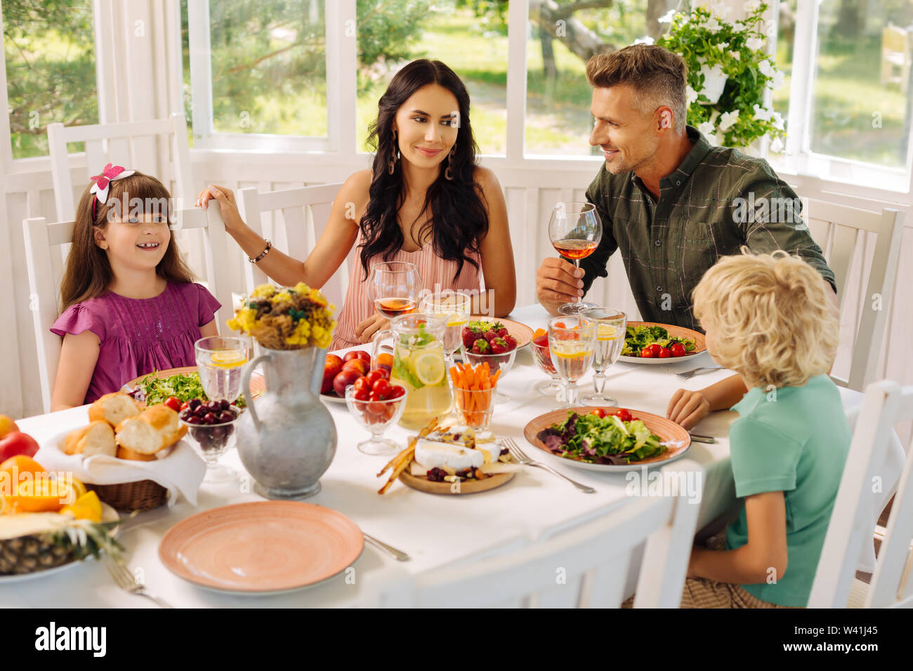 Children eating salads for lunch with their parents Stock Photo Alamy
