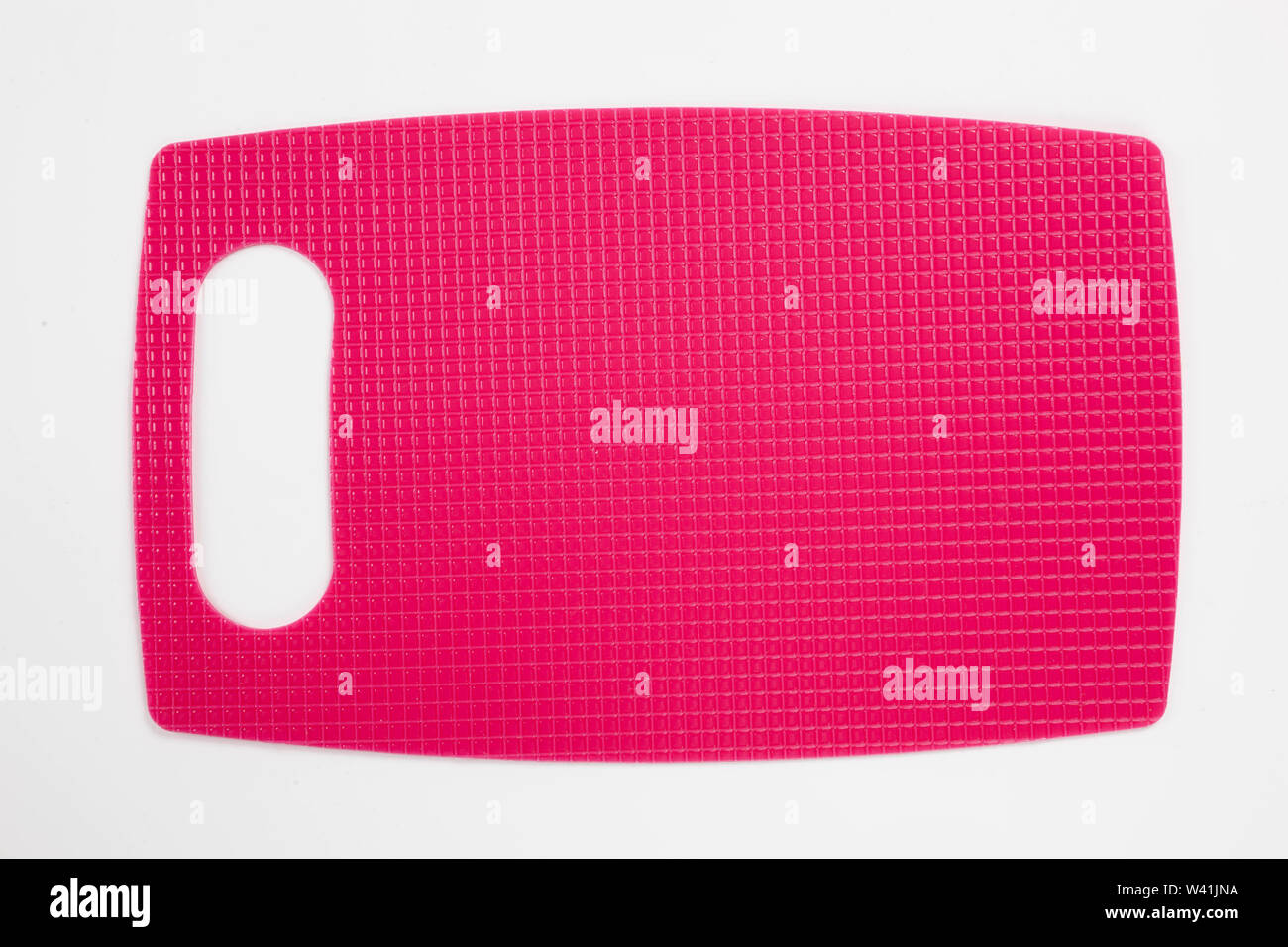 Pink plastic kitchen cutting board isolated on white background Stock Photo
