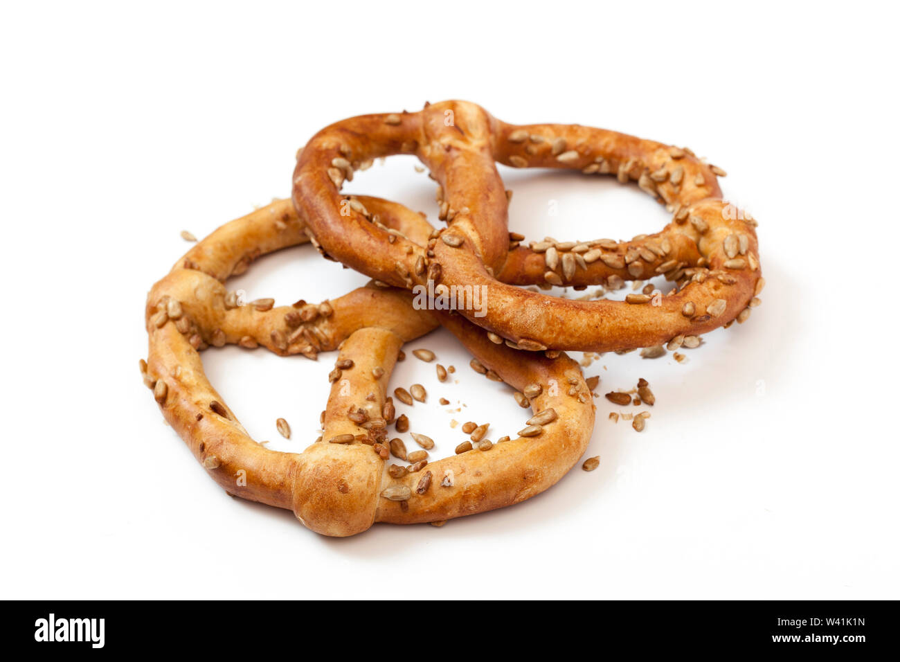 Two bavarian pretzel with sunflowers seeds isolated on white Stock