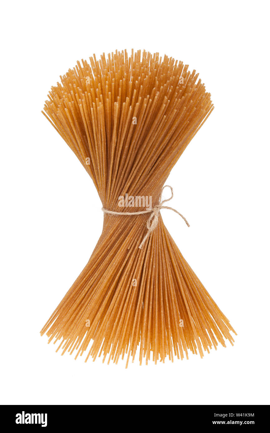 Bundle of uncooked wholegrain spaghetti isolated on white background Stock Photo