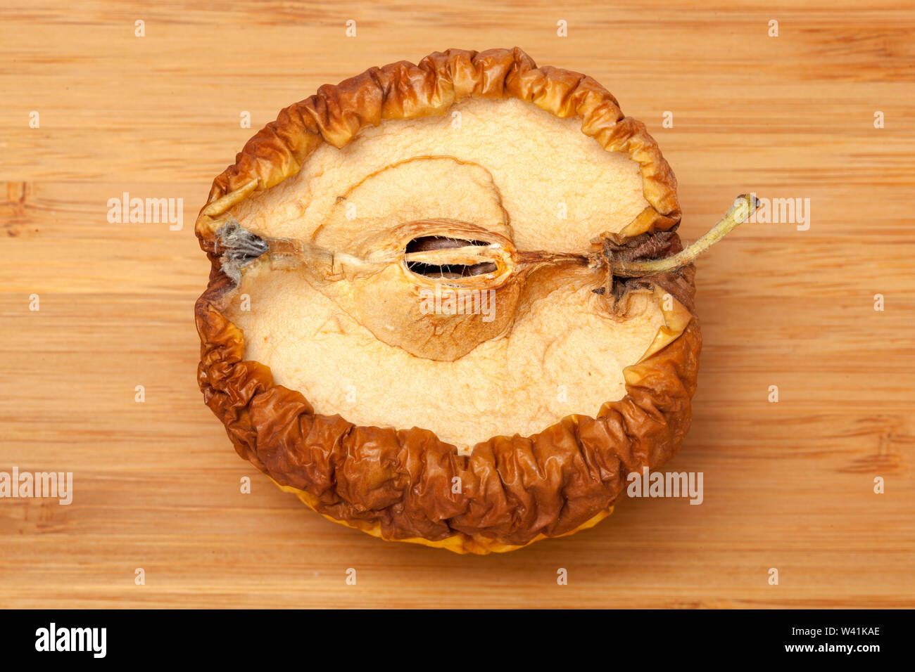 Rotten apple on wooden background Stock Photo