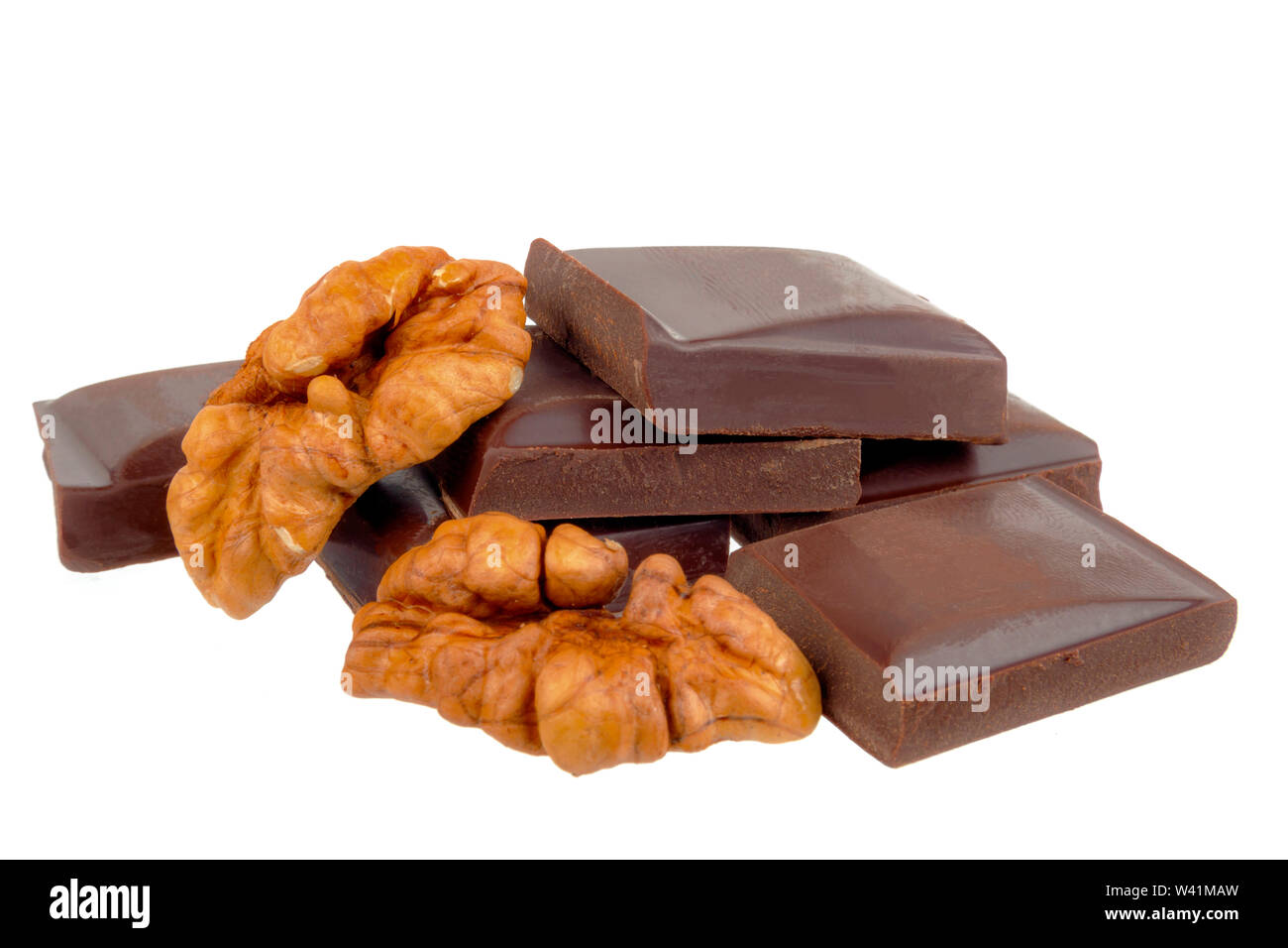 Chocolate bars lie with walnuts on a white background Stock Photo