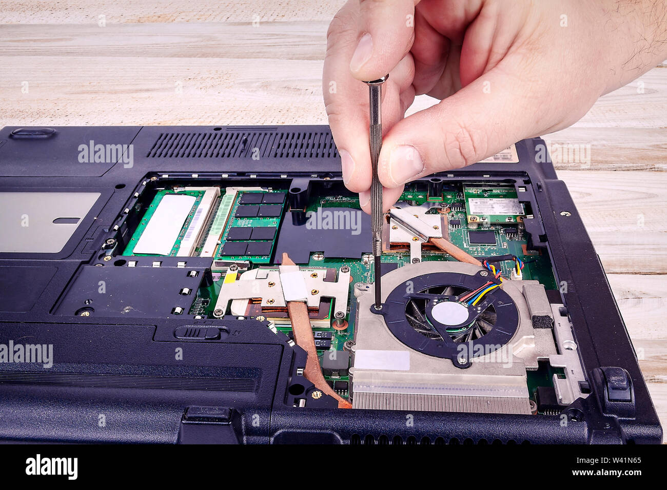 Unscrew the laptop fan to repair it Stock Photo Alamy