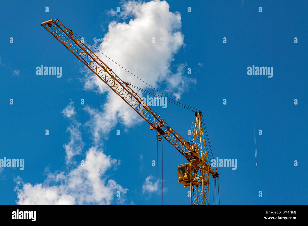 Construction crane against the blue sky with clouds Stock Photo - Alamy