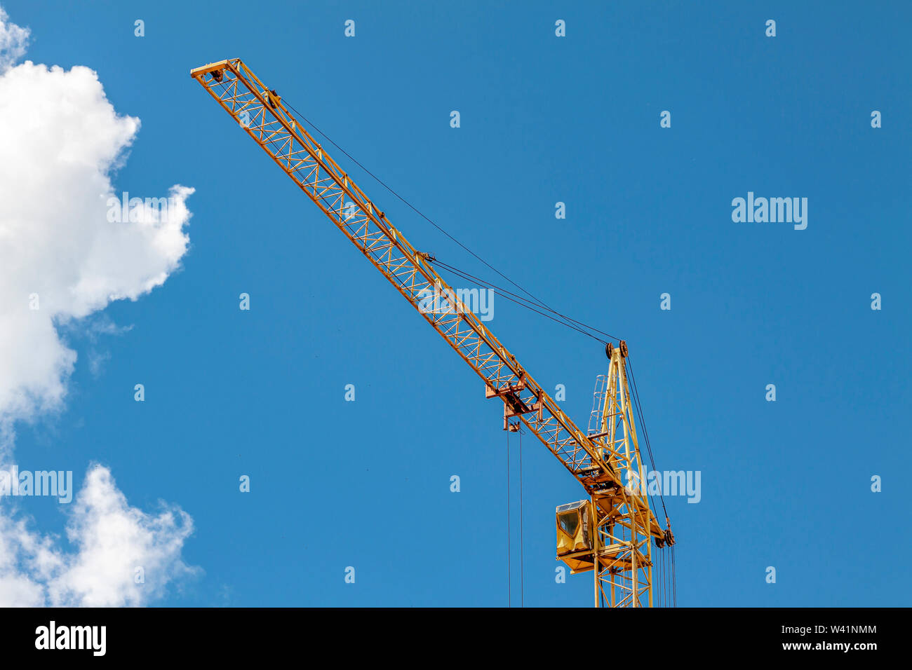 Construction crane against the blue sky with clouds Stock Photo - Alamy