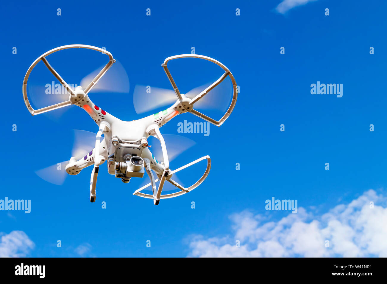 Kaluga, Russia 06/02/2019 Quadrocopter with a camera in flight against a blue sky. Stock Photo